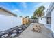 Backyard with patio and benches has both privacy fencing and open access to adjacent property at 456 Sandlewood Dr, Venice, FL 34293