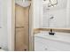 Bathroom with a glass door shower stall, modern white vanity and a decorative light fixture at 456 Sandlewood Dr, Venice, FL 34293