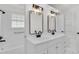 Bright bathroom with double sinks, modern fixtures, and a clean, updated design at 456 Sandlewood Dr, Venice, FL 34293