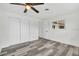 This bedroom has stylish, light-colored laminate floors and white walls with a standard closet and window at 456 Sandlewood Dr, Venice, FL 34293