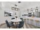 Open concept dining room and kitchen with modern light fixtures and breakfast bar at 456 Sandlewood Dr, Venice, FL 34293