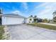 Exterior view showing a 2-car garage and driveway leading up to a charming home under a bright sky at 456 Sandlewood Dr, Venice, FL 34293