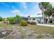 Well-maintained front yard with lush landscaping and a charming single-story home at 456 Sandlewood Dr, Venice, FL 34293