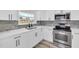 Modern kitchen with stainless steel appliances, sleek cabinetry, and stylish backsplash at 456 Sandlewood Dr, Venice, FL 34293