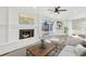 Cozy living room features a fireplace, sliding glass door, and built-in shelving at 456 Sandlewood Dr, Venice, FL 34293
