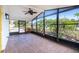 Screened-in lanai with lush landscaping views and a ceiling fan for added comfort on warm days at 456 Sandlewood Dr, Venice, FL 34293