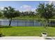 Manicured lawn with stunning water views framed by trees and an elegant wrought iron fence at 5150 San Palermo Dr, Bradenton, FL 34208