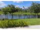 Lush backyard with manicured landscaping, decorative fence, and serene water view at 5150 San Palermo Dr, Bradenton, FL 34208