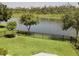 Backyard overlooking a peaceful pond with mature trees at 5150 San Palermo Dr, Bradenton, FL 34208