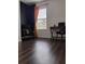 Bedroom featuring wood floors, a cozy chair, and a workspace with a modern desk at 5150 San Palermo Dr, Bradenton, FL 34208