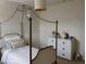 Bedroom featuring a four-poster bed and a white dresser at 5150 San Palermo Dr, Bradenton, FL 34208