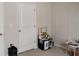 Bright bedroom corner with a play kitchen set near a white door on neutral carpeted flooring at 5150 San Palermo Dr, Bradenton, FL 34208