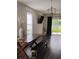 Inviting dining area with wood floors, elegant lighting, and views of the outdoors at 5150 San Palermo Dr, Bradenton, FL 34208