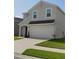 Two-story home featuring a wide driveway, a two-car garage, and well-maintained landscaping at 5150 San Palermo Dr, Bradenton, FL 34208