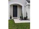 Inviting front entrance featuring a dark door, manicured landscaping, and modern house number at 5150 San Palermo Dr, Bradenton, FL 34208