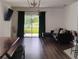 Modern living room showcasing a sleek black couch, wood floors, and natural light at 5150 San Palermo Dr, Bradenton, FL 34208