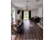Bright living room featuring hardwood floors, stylish furniture, and sliding glass doors at 5150 San Palermo Dr, Bradenton, FL 34208