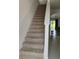Carpeted staircase leads to the upper level, with a view of the living area at 5150 San Palermo Dr, Bradenton, FL 34208