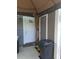 Back porch with a white door, brown door, and outdoor furniture, for relaxing at 6640 121St Ave # 1, Largo, FL 33773