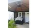 Covered porch featuring an outdoor grill, privacy curtains, and tiled flooring, offering a relaxing outdoor space at 6640 121St Ave # 1, Largo, FL 33773