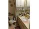 Traditional bathroom with a vanity, sink, toilet, and mirrored cabinet at 6640 121St Ave # 1, Largo, FL 33773