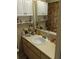 Bathroom featuring a single sink vanity with mirror, storage and a floral shower curtain at 6640 121St Ave # 1, Largo, FL 33773