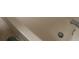 Bright bathtub with tile surround and chrome fixtures, ideal for relaxation at 6640 121St Ave # 1, Largo, FL 33773