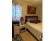Bedroom featuring a cozy bed, nightstand, and closet at 6640 121St Ave # 1, Largo, FL 33773