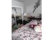 Bedroom featuring a bed with floral patterned bedding and mirrored closet doors at 6640 121St Ave # 1, Largo, FL 33773