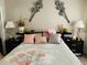 Bedroom features a bed with decorative pillows, lamps, and unique wall decor at 6640 121St Ave # 1, Largo, FL 33773