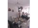 Cozy dining area featuring a glass table, four chairs, a chandelier, and decorative wall art at 6640 121St Ave # 1, Largo, FL 33773