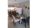Cozy dining area featuring a round glass table, stylish chairs, and elegant chandelier, perfect for intimate meals at 6640 121St Ave # 1, Largo, FL 33773