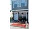 Charming two-story townhome featuring gray siding, white trim, shutters, and a welcoming front entrance with landscaped flowerbeds at 6640 121St Ave # 1, Largo, FL 33773