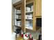 Kitchen cabinets filled with dishes and a collection of cooking utensils for easy meal preparation at 6640 121St Ave # 1, Largo, FL 33773