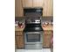 Kitchen showcasing a stainless steel stove, wood cabinets, and decorated countertop at 6640 121St Ave # 1, Largo, FL 33773