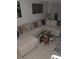 Comfortable living room with an oversized sectional couch, a glass coffee table and plenty of space to relax at 6640 121St Ave # 1, Largo, FL 33773