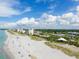 Scenic coastal community featuring a sandy beach, lush landscaping, and inviting amenities at 811 Laguna Dr, Venice, FL 34285