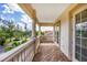 A cozy balcony features brick flooring, and stone railing, with views of the property's surrounding neighborhood at 811 Laguna Dr, Venice, FL 34285