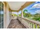 An outdoor balcony features brick flooring, stone railing, and views of the property's landscaping and neighborhood at 811 Laguna Dr, Venice, FL 34285