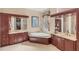 Luxurious bathroom featuring a soaking tub, dual vanities, and elegant finishes at 811 Laguna Dr, Venice, FL 34285