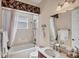 A well-maintained bathroom features a bathtub, shower, and ample counter space with a mirror at 811 Laguna Dr, Venice, FL 34285