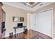 A furnished bedroom features hardwood floors, a ceiling fan, and a closet with white paneled doors at 811 Laguna Dr, Venice, FL 34285
