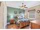 Charming bedroom with a ceiling fan, hardwood floors, and a well-lit window at 811 Laguna Dr, Venice, FL 34285