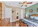 Comfortable bedroom with hardwood floors, a ceiling fan, and an ensuite bathroom at 811 Laguna Dr, Venice, FL 34285