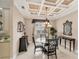 Elegant dining room featuring tray ceilings, a chandelier, and a glass table at 811 Laguna Dr, Venice, FL 34285