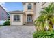 Grand front entrance with decorative columns, arched windows, and well-maintained landscaping at 811 Laguna Dr, Venice, FL 34285