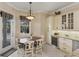 Cozy kitchen area with seating for four and custom cabinetry at 811 Laguna Dr, Venice, FL 34285