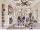 Elegant living room with high ceilings, a fireplace, and staircase access at 811 Laguna Dr, Venice, FL 34285