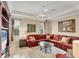 A well lit living room area features a modern ceiling fan and plush seating with lots of pillows at 811 Laguna Dr, Venice, FL 34285