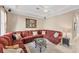 A comfortable living room area includes a cozy couch, lots of pillows, and a modern ceiling fan at 811 Laguna Dr, Venice, FL 34285